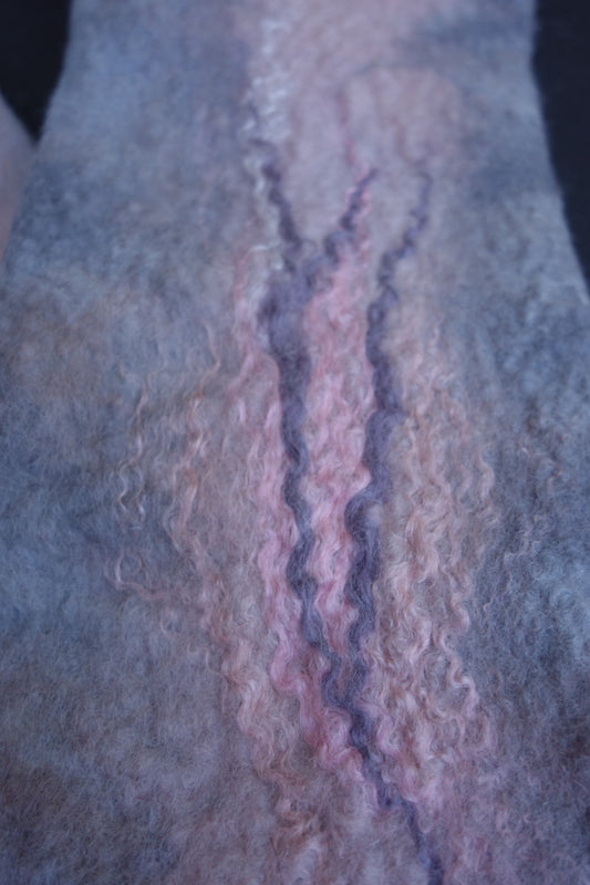 Close-up of pink and lavender fiber detail on hand-felted fingerless gloves