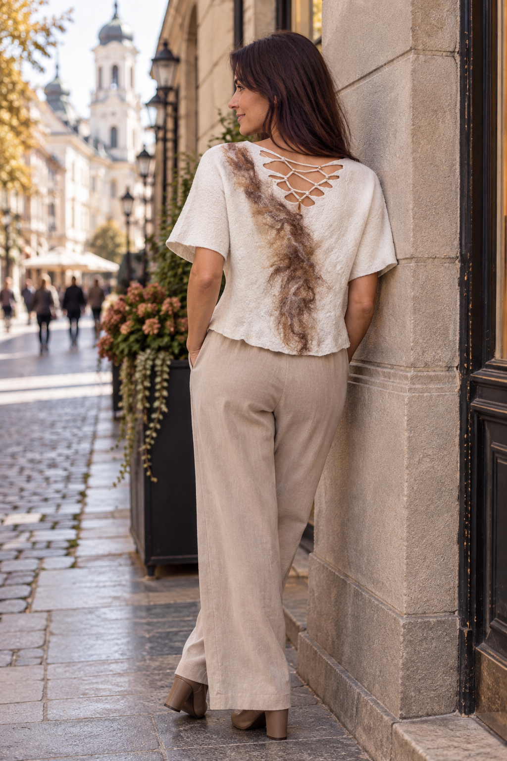Ivory and taupe felted wool top worn with neutral trousers, sculptural back view