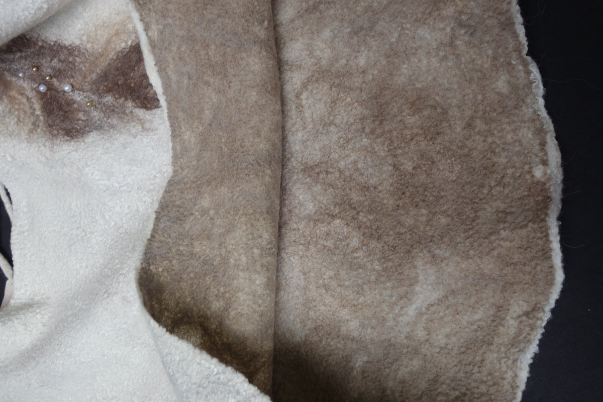 Close-up of handmade felted wool fabric and taupe fiber detail