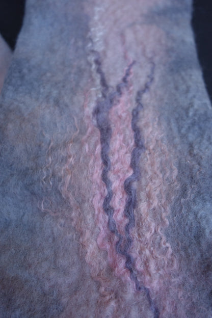 Close-up of pink and lavender fiber detail on hand-felted fingerless gloves