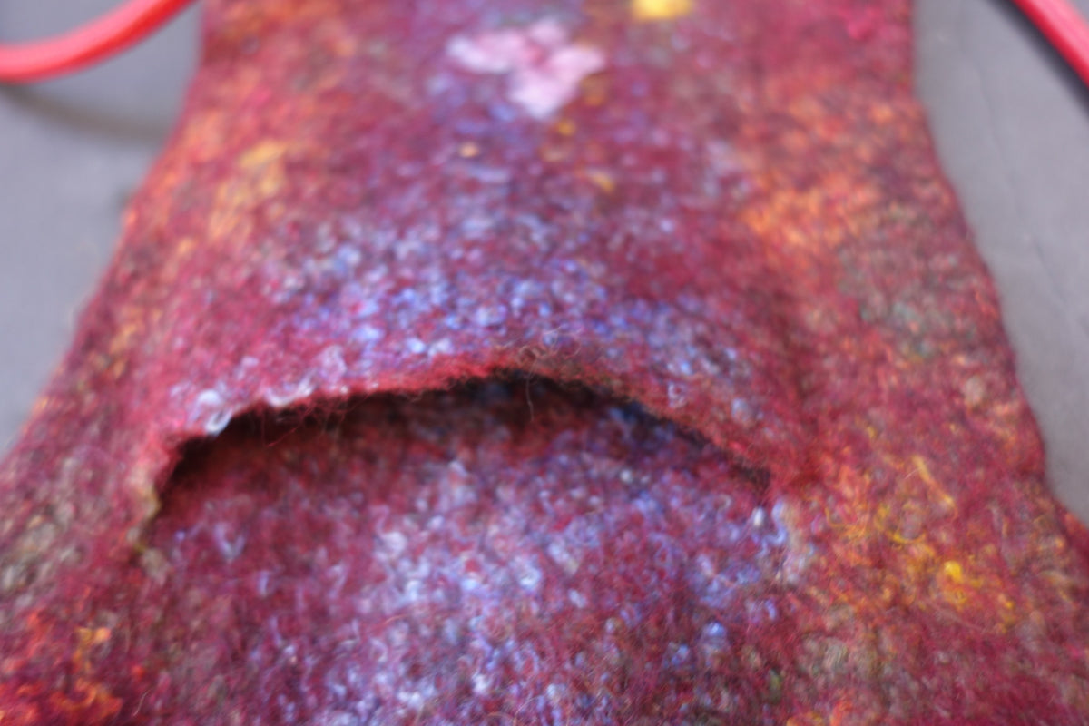 Close-up of back phone pocket on Butterfly Fire hand-felted bag
