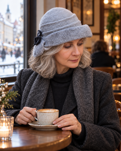 Silver grey asymmetric felted hat styled in a café