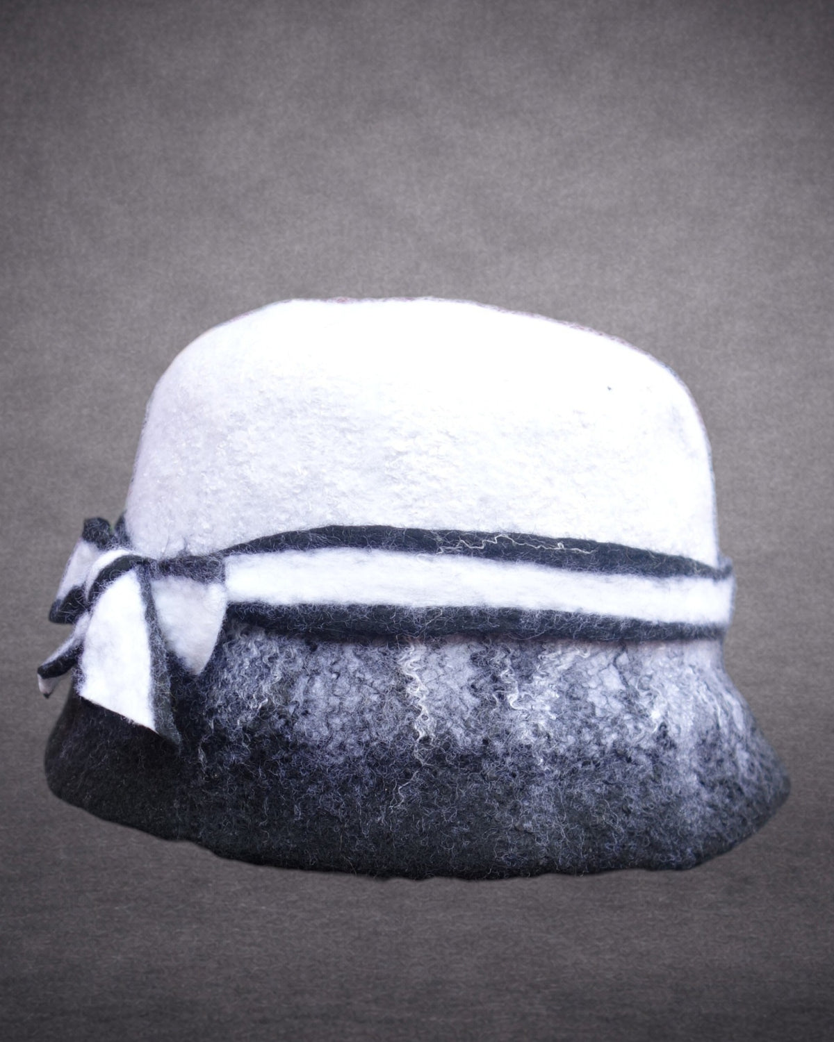 Black and white hand-felted merino wool hat side view