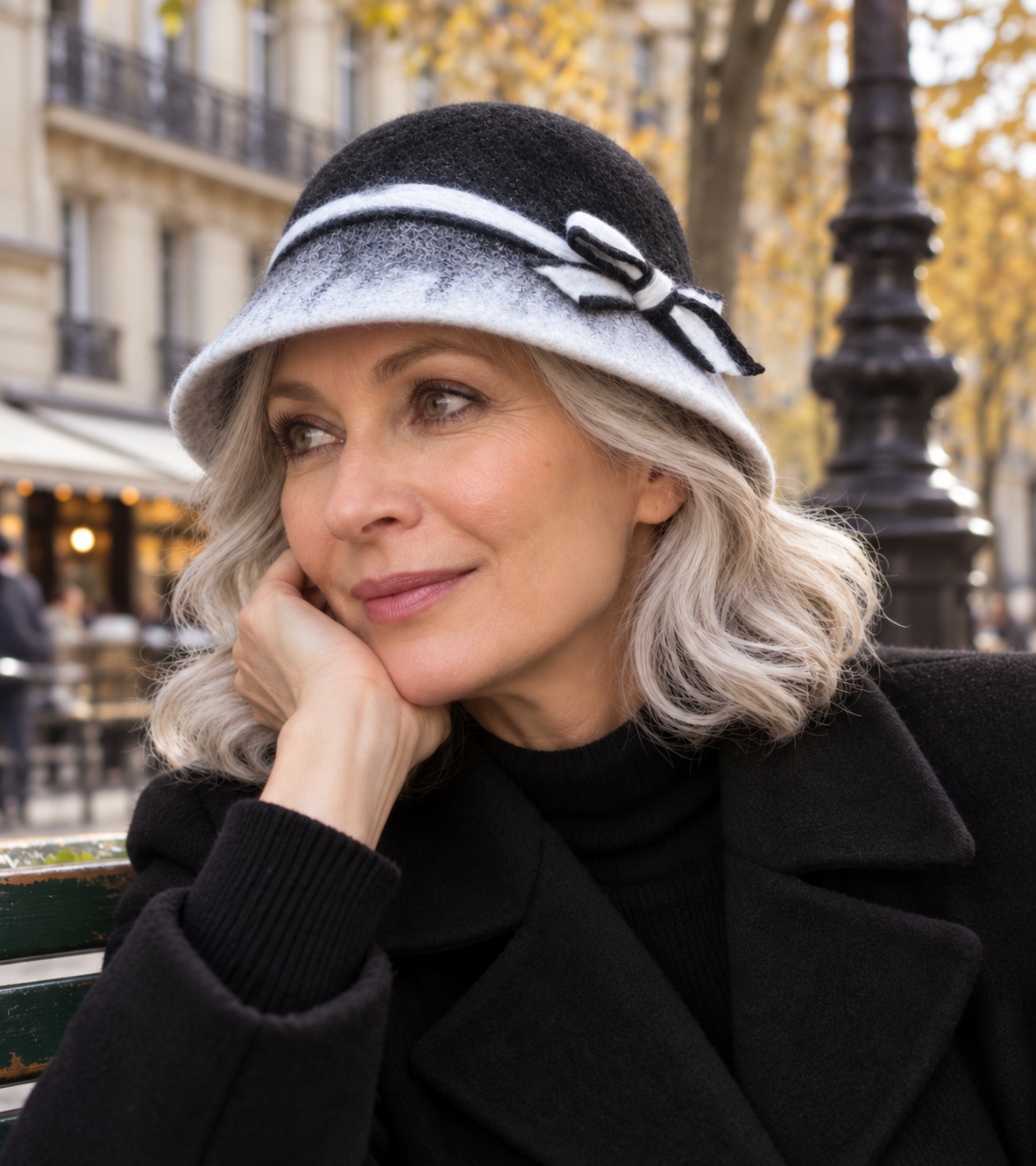 Black and white soft hand-felted bucket hat with bow worn outdoors