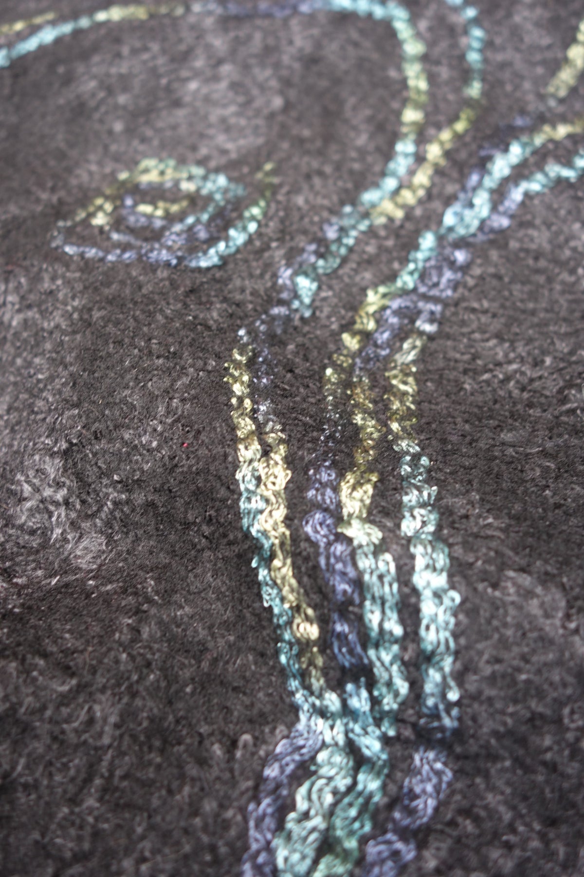 Close-up of blue green textured reverse side on Fire in the Night poncho