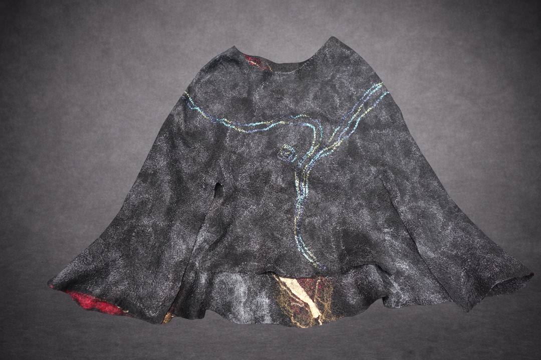 Fire in the Night poncho reverse side laid flat, alternate blue green view