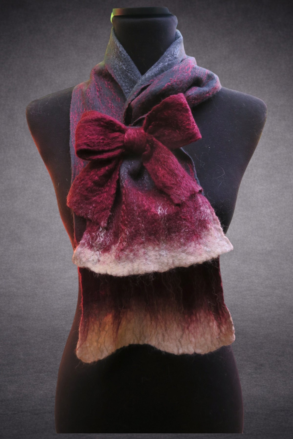 Grey-blue and burgundy felted scarf with attached bow on mannequin