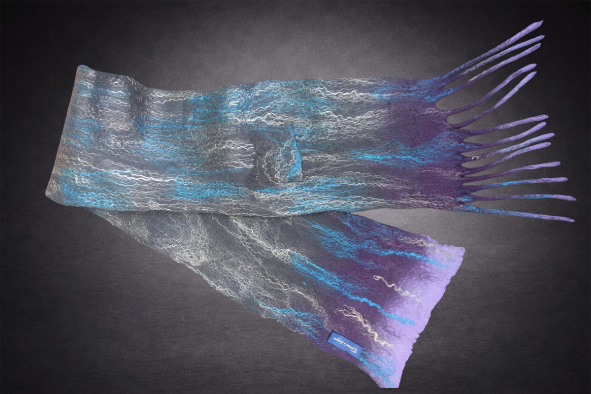 Grey, turquoise and purple hand-felted merino wool scarf laid flat