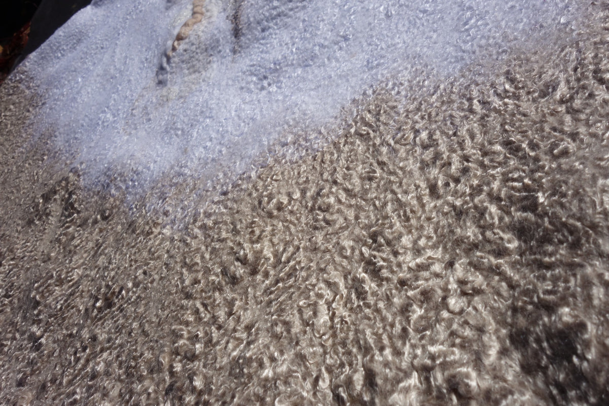 Close-up of sand-toned textured fibers on Ivory Sands poncho
