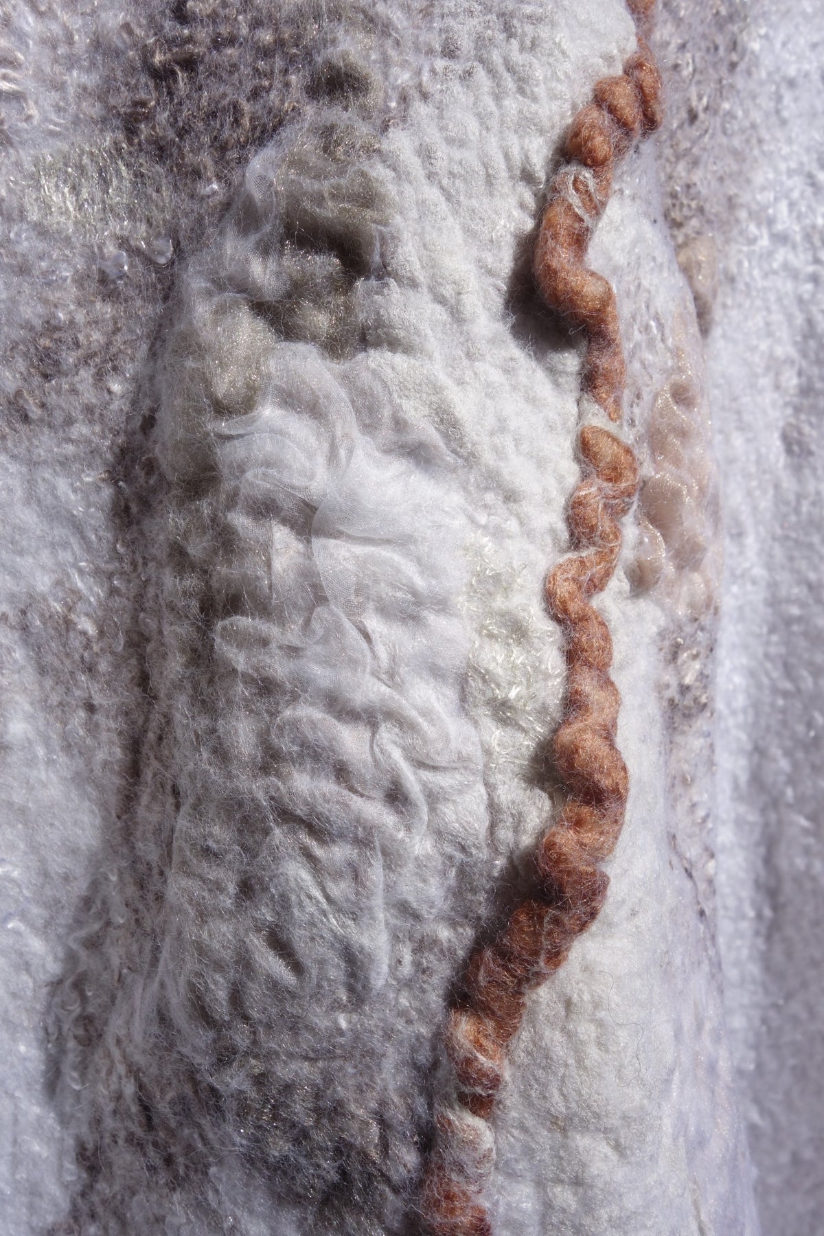 Close-up of layered silk and felt texture on Ivory Sands poncho