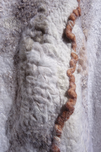 Close-up of layered silk and felt texture on Ivory Sands poncho