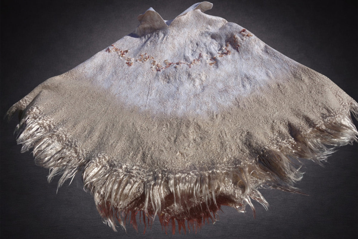 Ivory Sands poncho laid flat, lighter white side