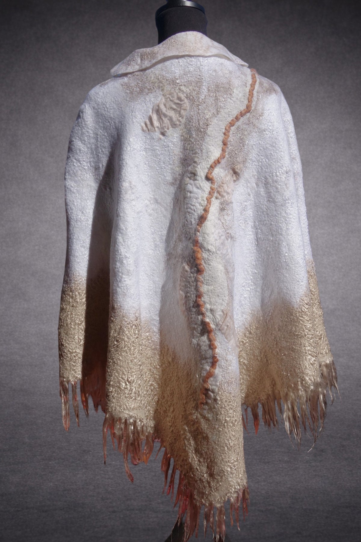 Ivory Sands reversible nuno-felted poncho on mannequin, back view