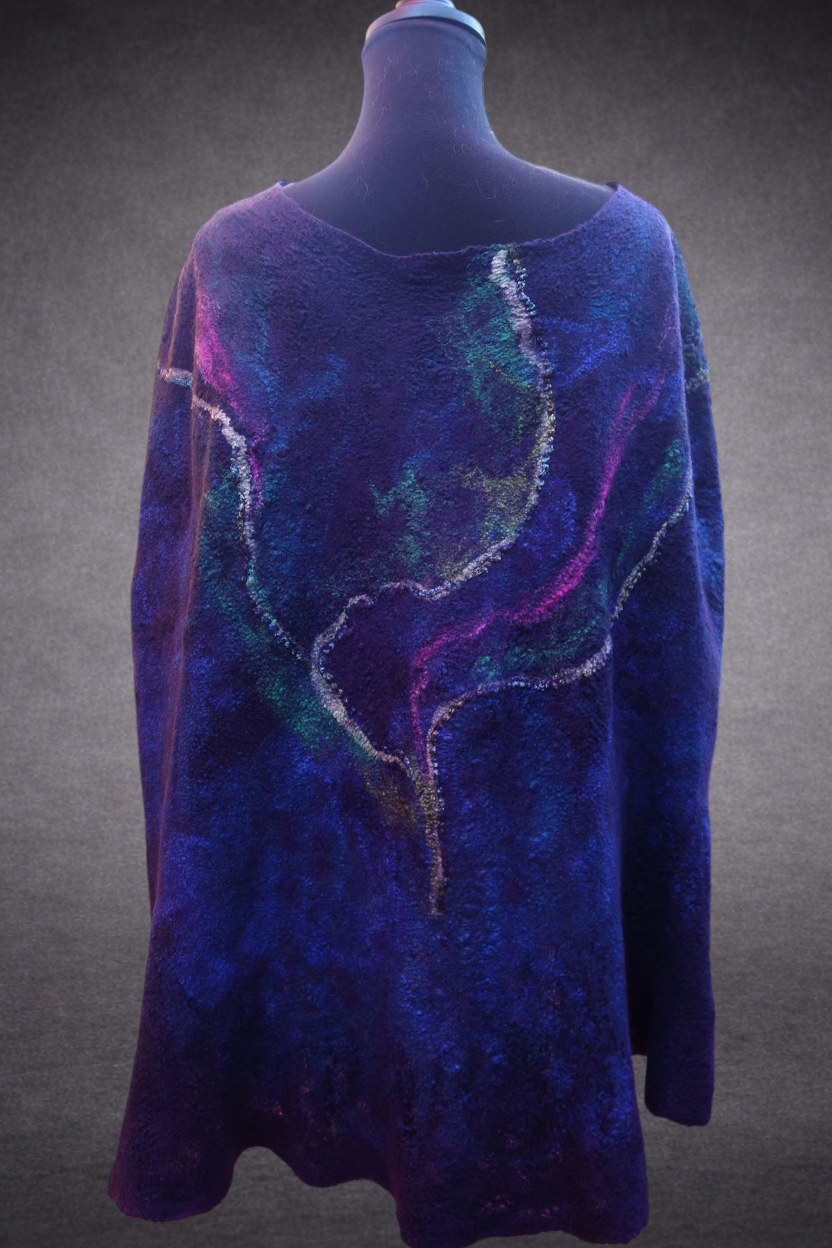 Northern Lights reversible hand-felted poncho, purple reverse side with yarn texture