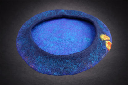 Inside view of blue hand-felted beret showing soft construction and floral accents