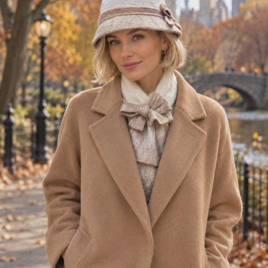 Ivory and beige hand-felted bucket hat shown in motion