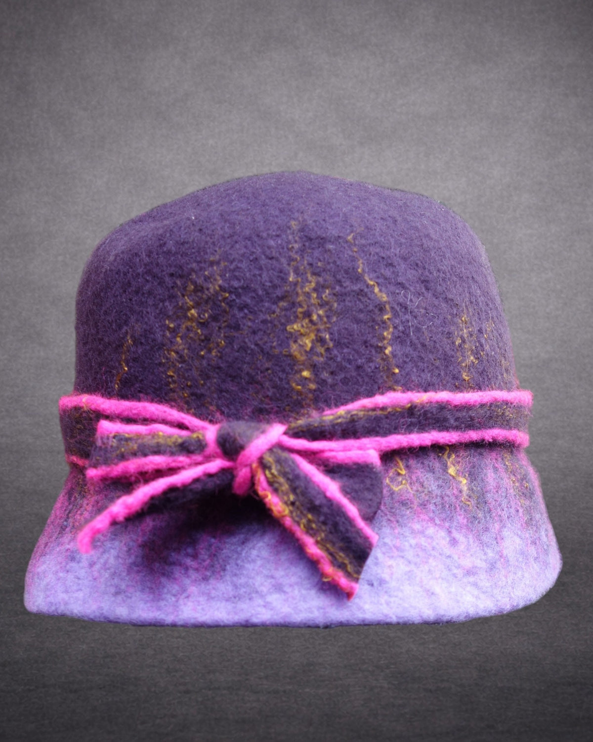 Hand-felted purple bucket hat with fuchsia edged bow and gold fiber accents