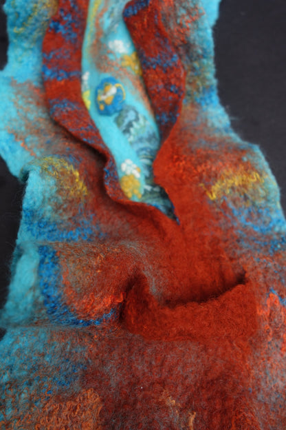 Turquoise and terracotta sculptural scarf styled on model
