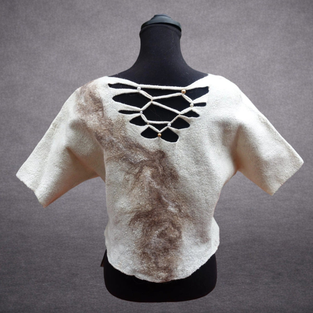 Ivory and taupe handmade felted wool top on mannequin, front view