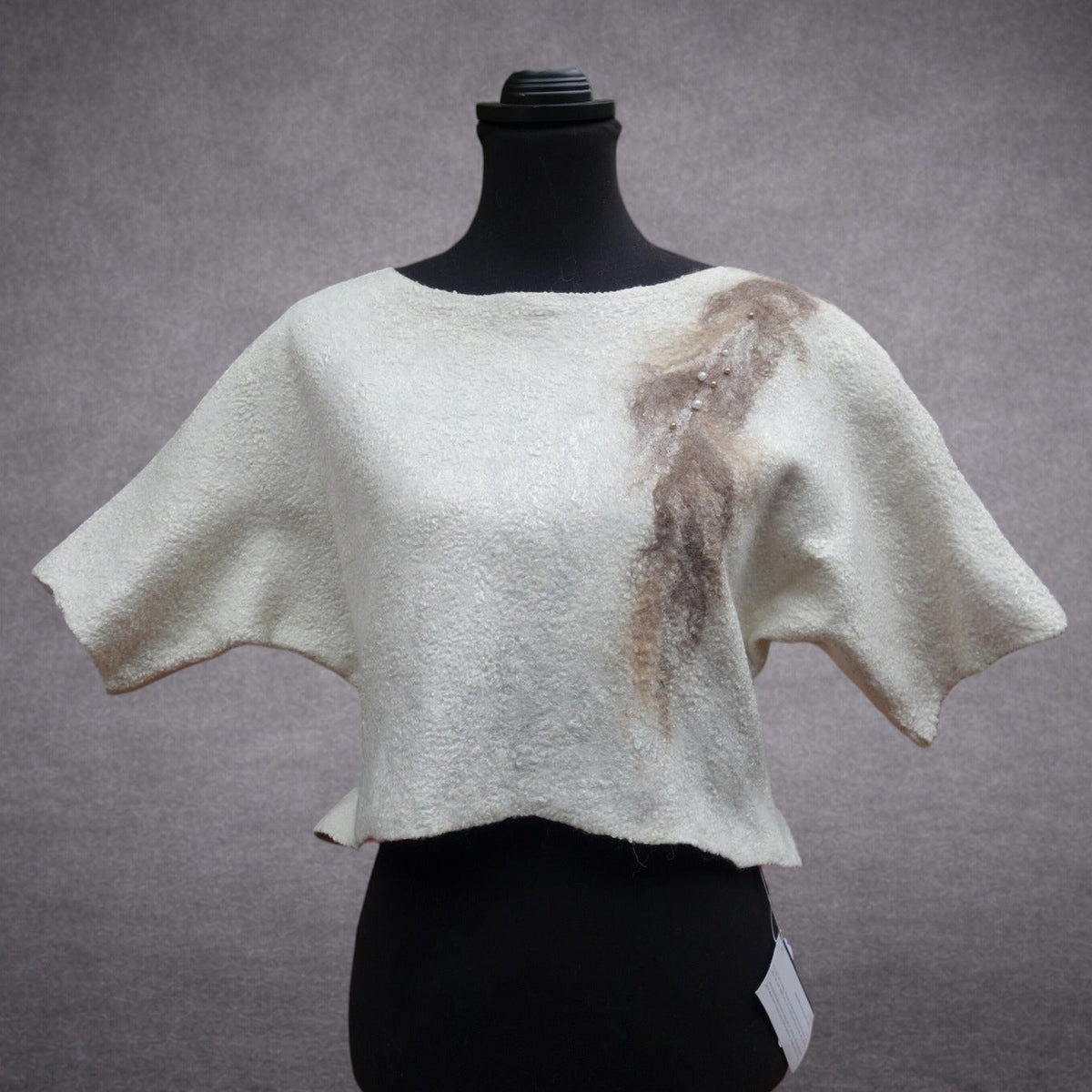 Ivory and taupe handmade felted wool top on mannequin, back view