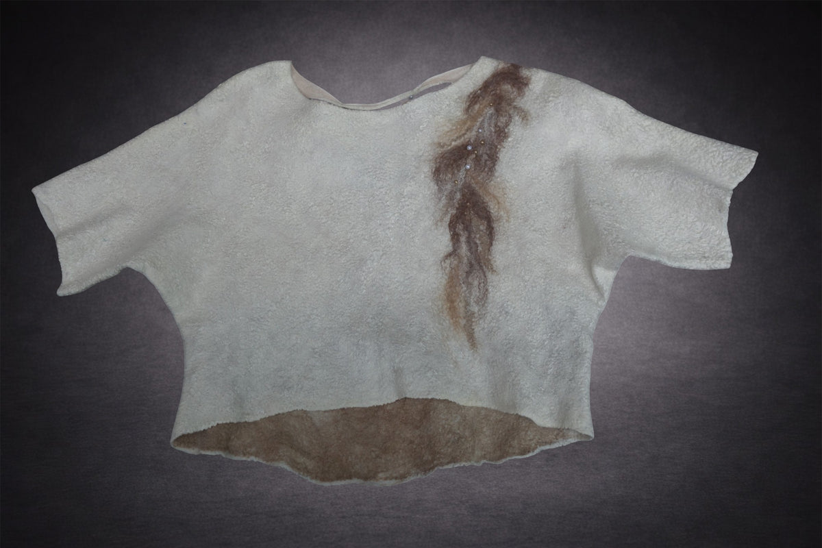 Handmade felted wool top laid flat, ivory front with taupe fiber detail