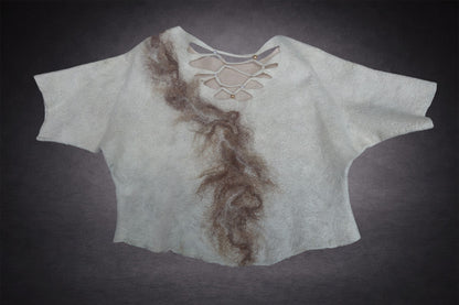 Handmade felted wool top laid flat showing sculptural openwork back neckline